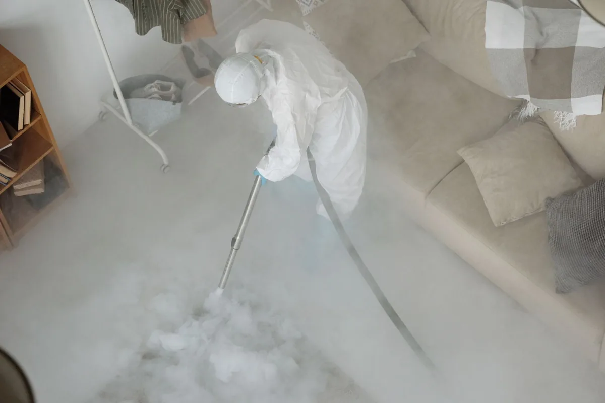 Biohazard cleanup technician in protective equipment, Metcalfe, MS